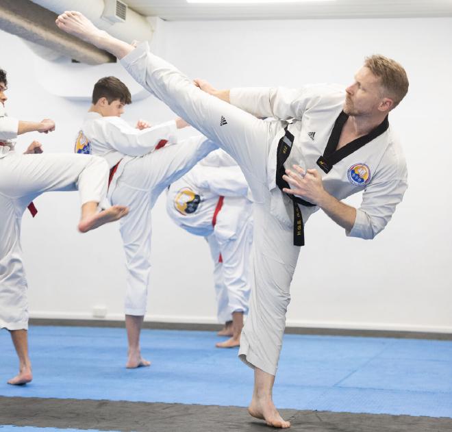 Roundhouse kick instruction in class